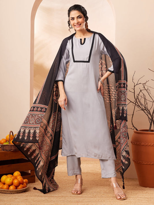 Naanu grey rayon straight kurta set with black contrast border and printed dupatta. Model is wearing 3/4 sleeves and straight pants.
