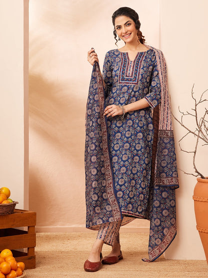 Naanu Indigo blue cotton 3-piece Ajrakh block print kurta, pants, and dupatta set with floral motifs and stripe details.