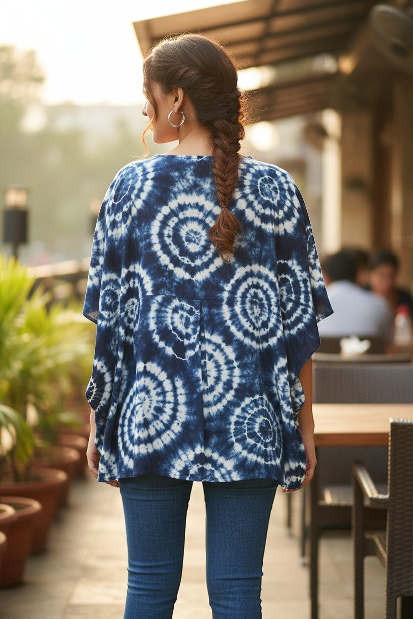 Naanu white and indigo blue shibori tie-dye A-line top with batwing sleeves and mirror work neckline.