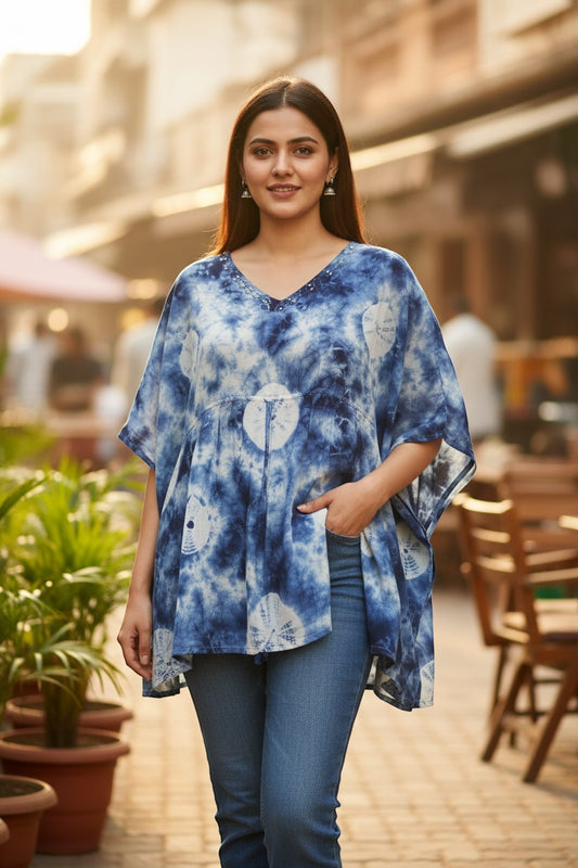 Naanu white and indigo blue shibori tie-dye cotton top with V-neck, mirror work, and batwing sleeves.