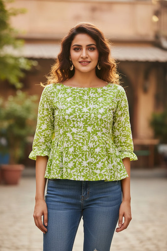 Naanu lime green and white floral print 3/4 sleeve peplum top made of 100% cotton with a boat neckline and ruffled cuffs.