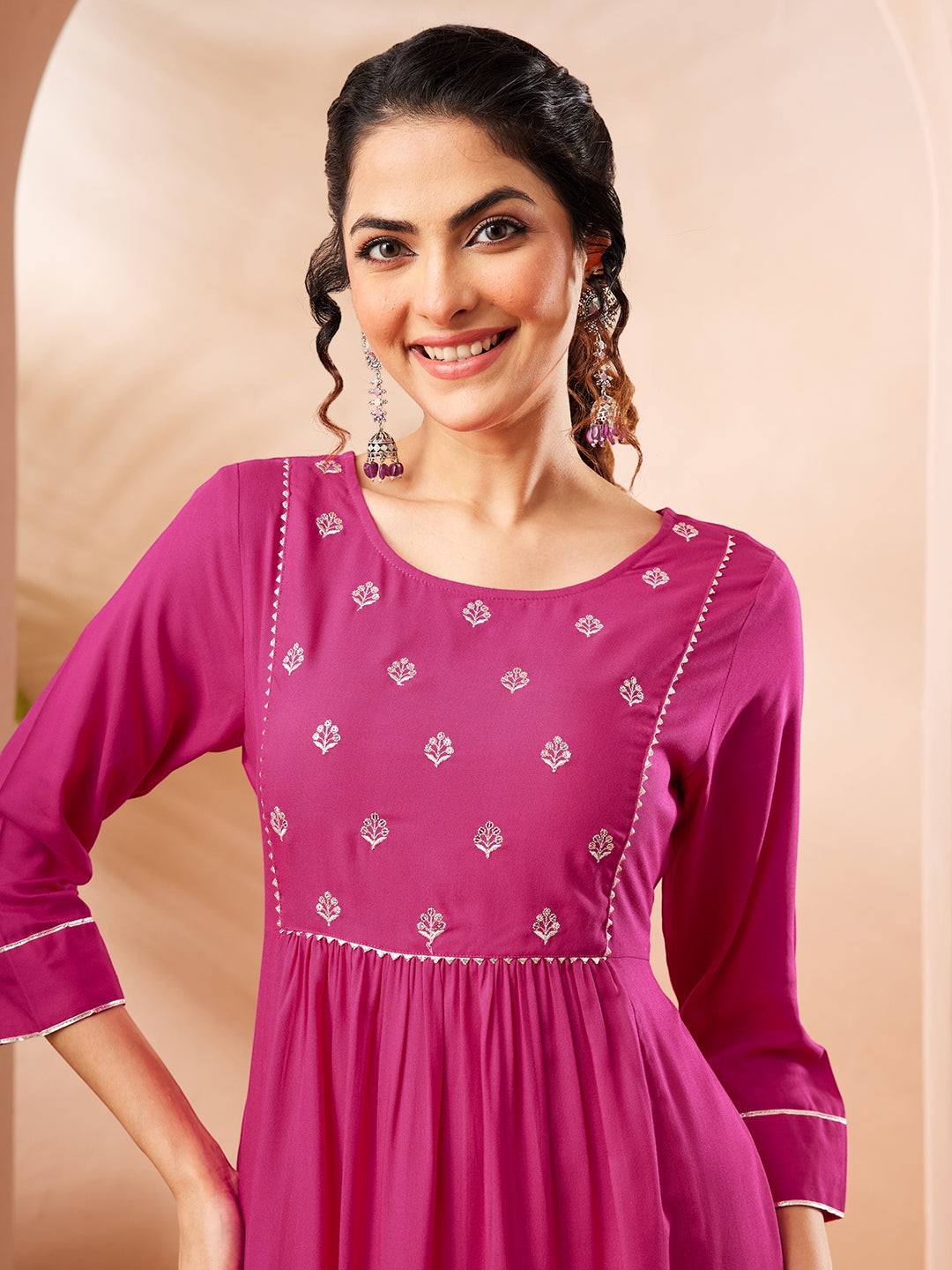 Naanu magenta Anarkali kurta with white butti embroidery on yoke and lace trim on cuffs and hem.