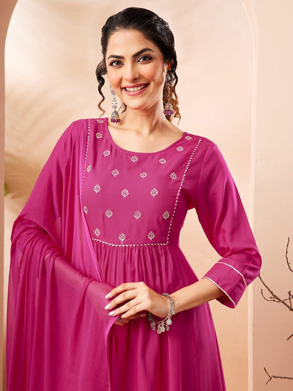 Naanu magenta Anarkali kurta set with white butti embroidery on yoke and lace trim on cuffs and hem. Includes pants and dupatta.