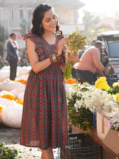 Naanu maroon cotton midi dress with Ajrakh medallion print, square neck, and ruffle flutter sleeves.