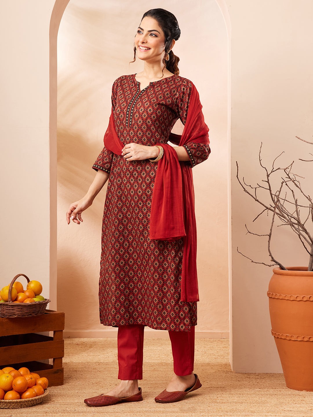 Naanu maroon cotton kurta with diamond print, keyhole neckline, embroidered placket, 3/4 sleeves, matching pants and crimson dupatta.