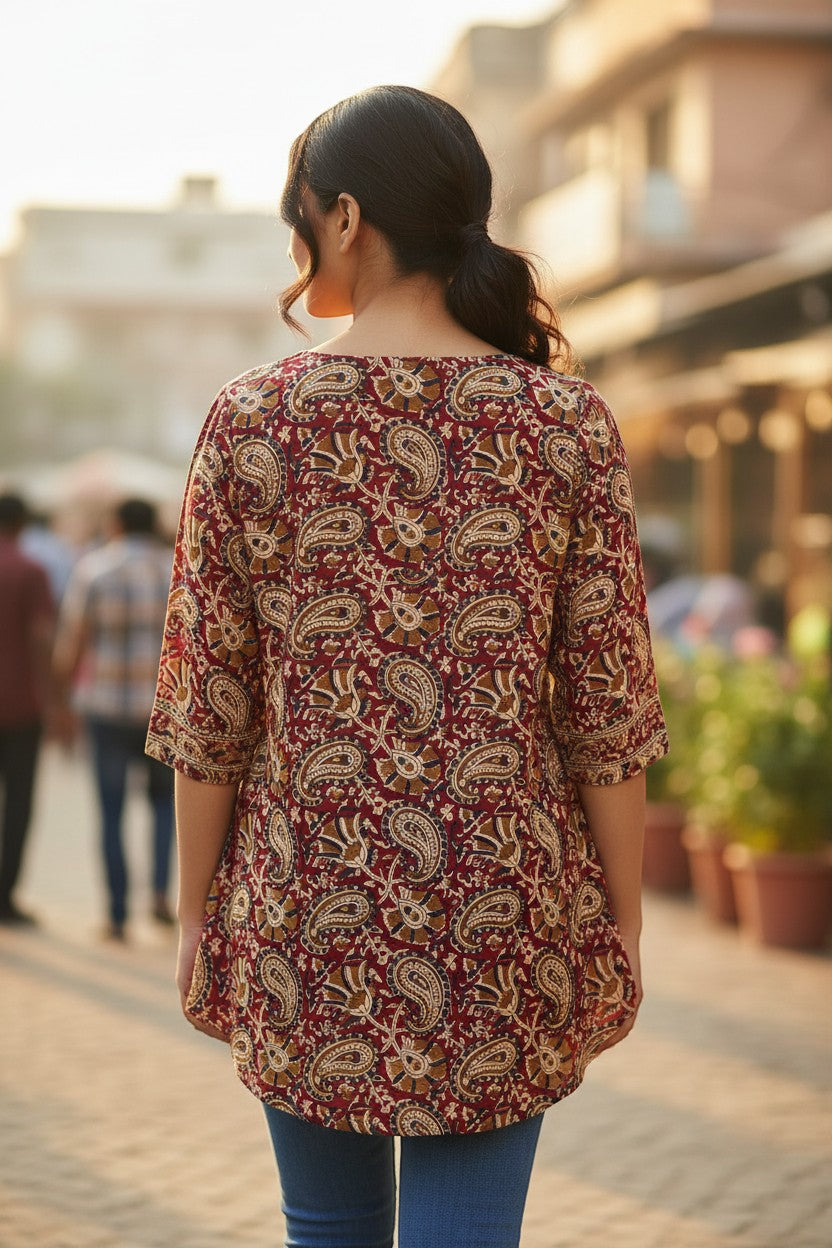 Naanu maroon red cotton short top with cream gold paisley and peacock block print, round neck, 3/4 sleeves, and asymmetric hem.
