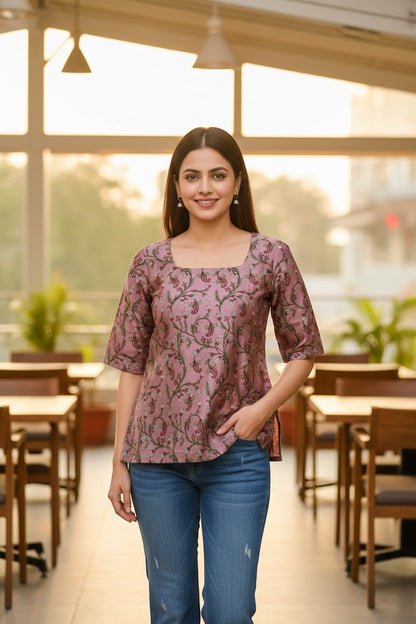 Naanu mauve pink cotton kurti with paisley vine print, square neck, and 3/4 sleeves. Model wears jeans.