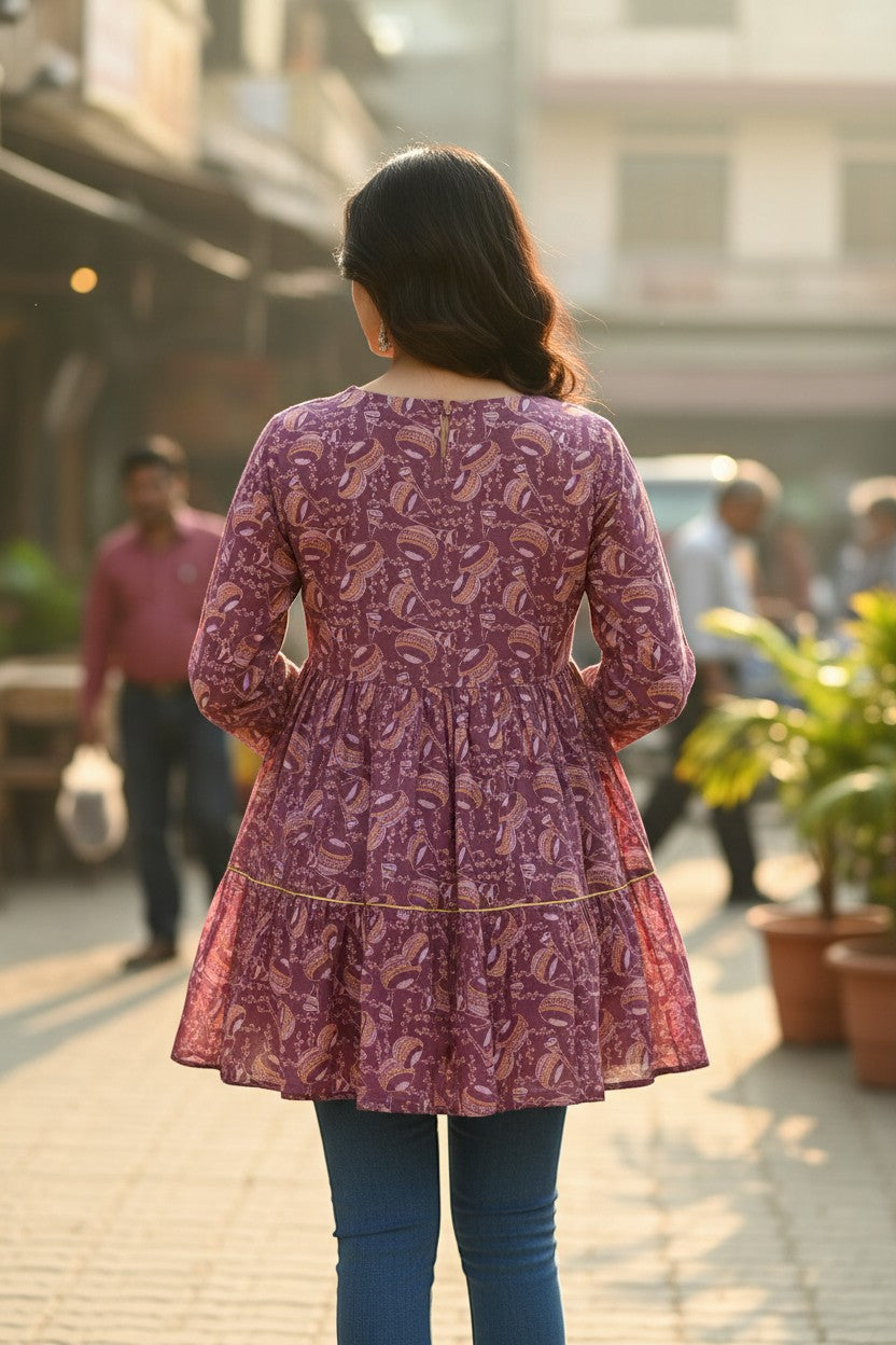 Naanu mauve purple cotton tiered frock kurti with paisley print, lace belt, and gold trim.