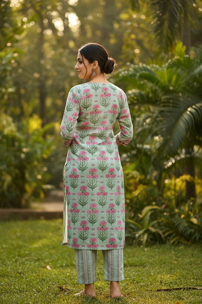 Naanu mint green floral block print kurta with mirror embroidered V-neck and striped pants. 3/4 sleeves, straight hem, side slits.