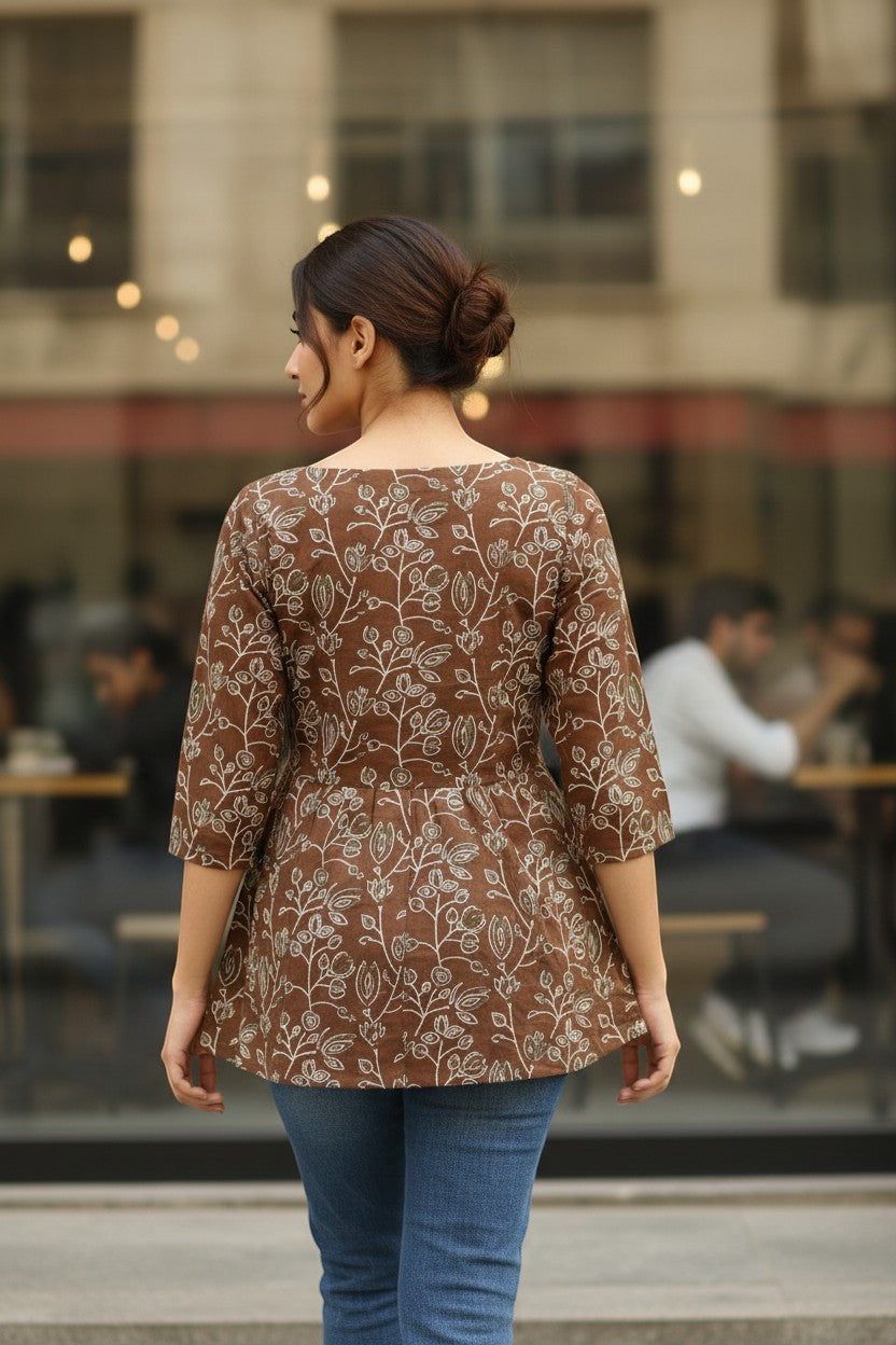 Naanu mocha brown cotton kurti with white Kantha floral vine print, boat neck, and 3/4 sleeves.