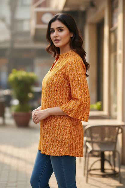 Naanu mustard orange cotton kurti with diamond dot Bandhani print, V-neck, mandarin collar, and 3/4 bell sleeves.