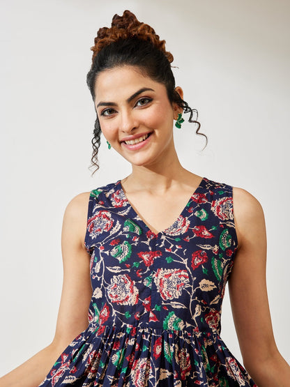 Naanu navy cotton midi dress with V-neck, sleeveless, empire waist, and tiered border hem with floral print.