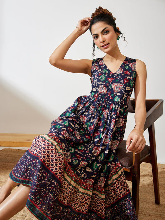Naanu navy cotton midi dress with V-neck, empire waist, and tiered border hem featuring a Kalamkari floral print.