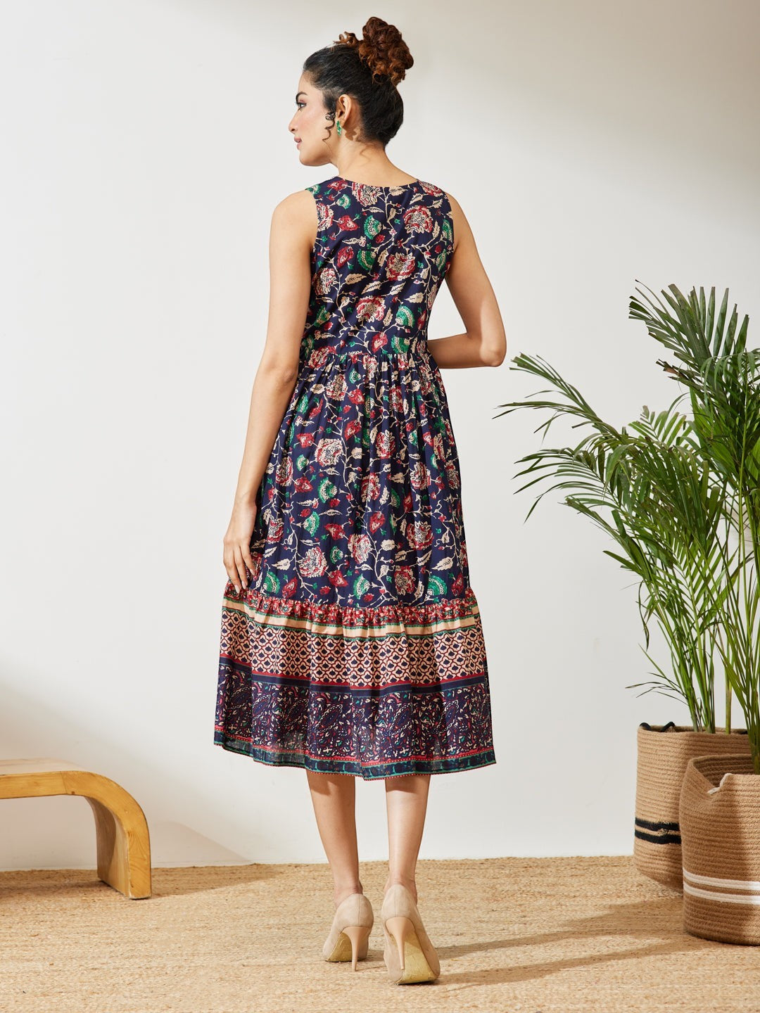 Naanu navy cotton midi dress with Kalamkari floral print, V-neck, empire waist, and tiered border hem.
