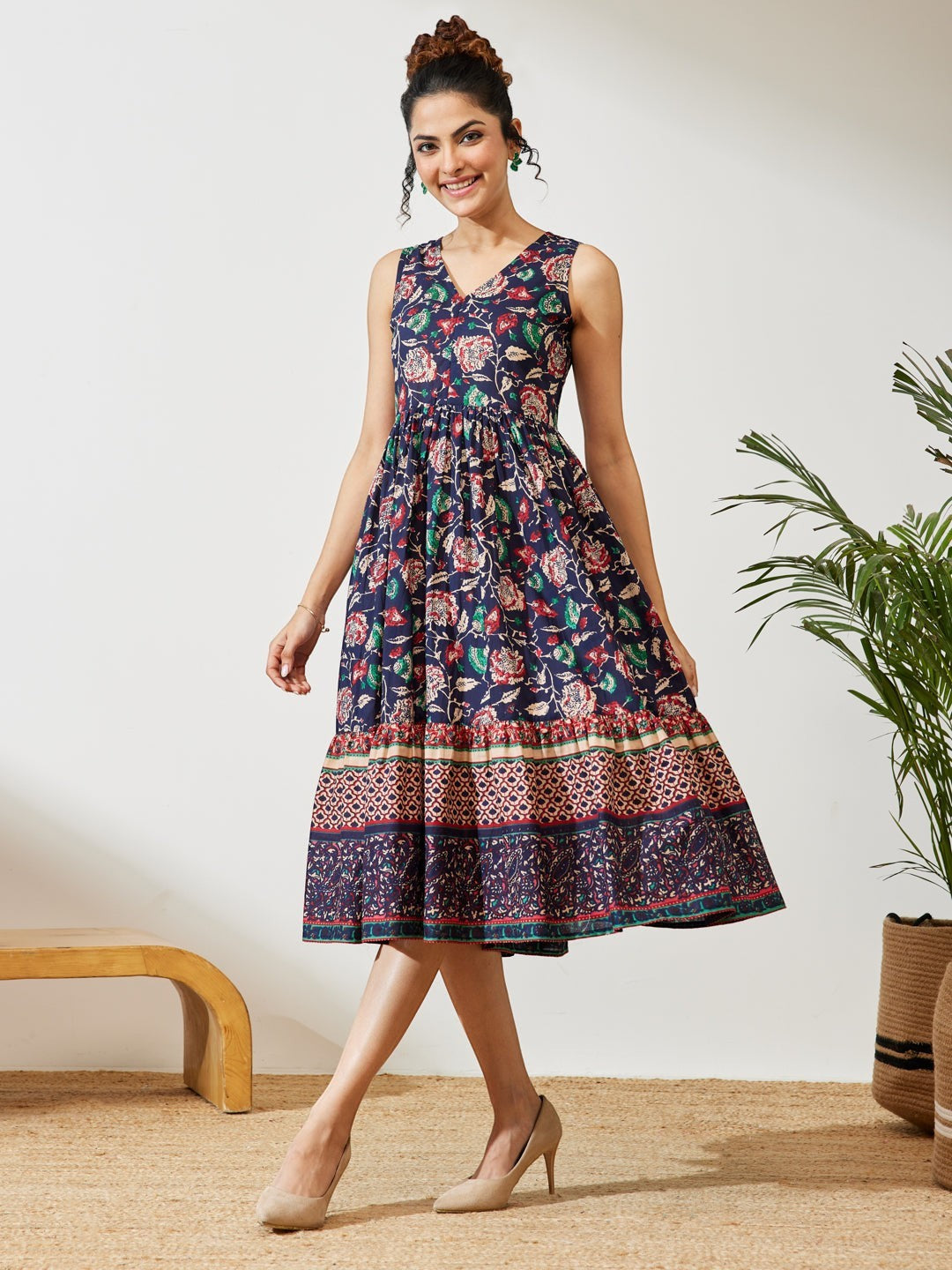 Naanu navy cotton midi dress with V-neck, empire waist, and tiered border hem featuring a Kalamkari floral print.