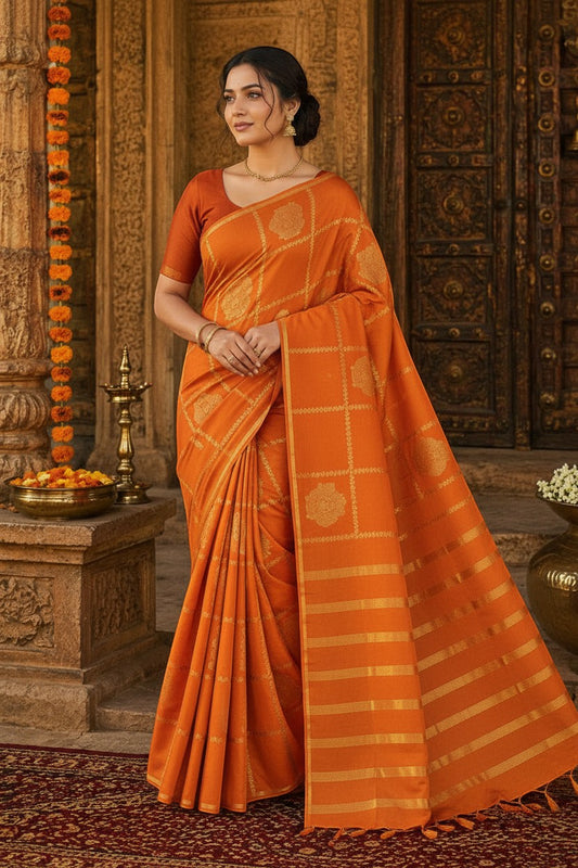 Naanu orange crepe silk saree with gold deity motifs and golden stripe pallu. Borderless design with a modern, sleek look. Ideal for bridal or festive wear.