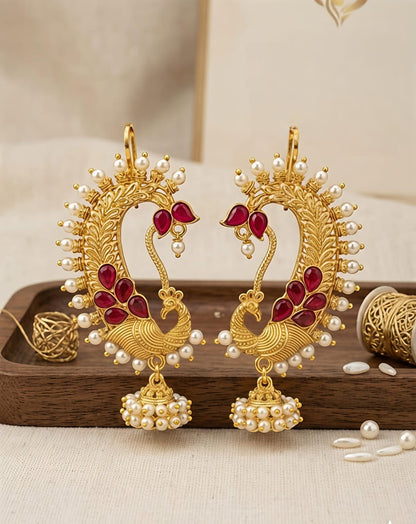 Naanu gold peacock chand bali earrings with ruby kemp stones and pearl jhumka drops. Traditional Indian temple jewellery.