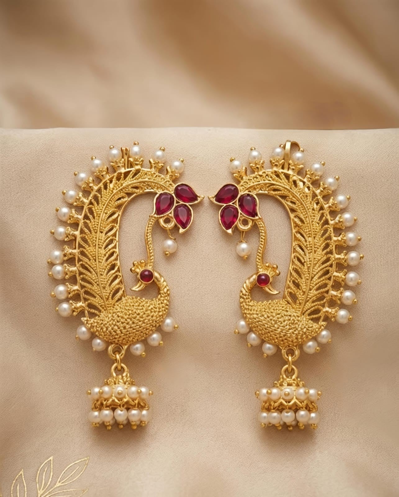 Naanu gold peacock feather temple earrings with ruby kemp stones and pearl jhumka drops.
