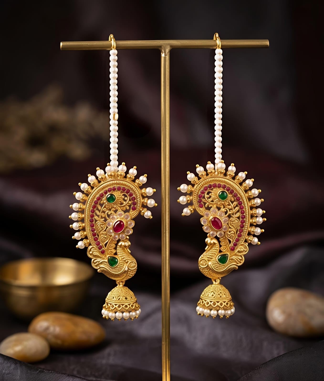 Naanu gold-toned peacock paisley jhumka earrings with pearl chain, ruby and emerald stones.