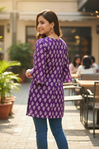 Naanu royal purple cotton kurti with white dabu floral print and 3/4 bell sleeves, worn by a woman.