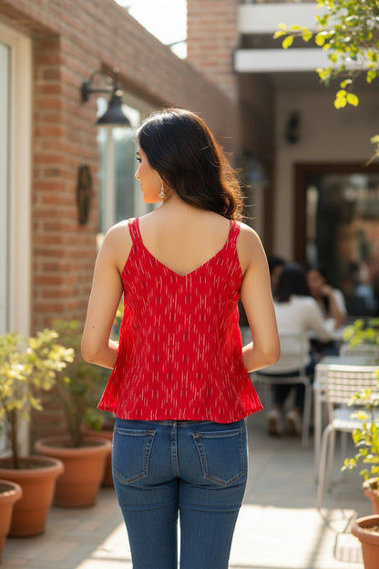Naanu red and white ikat sleeveless flared crop top with V-neck and tie detail, made of handwoven cotton.