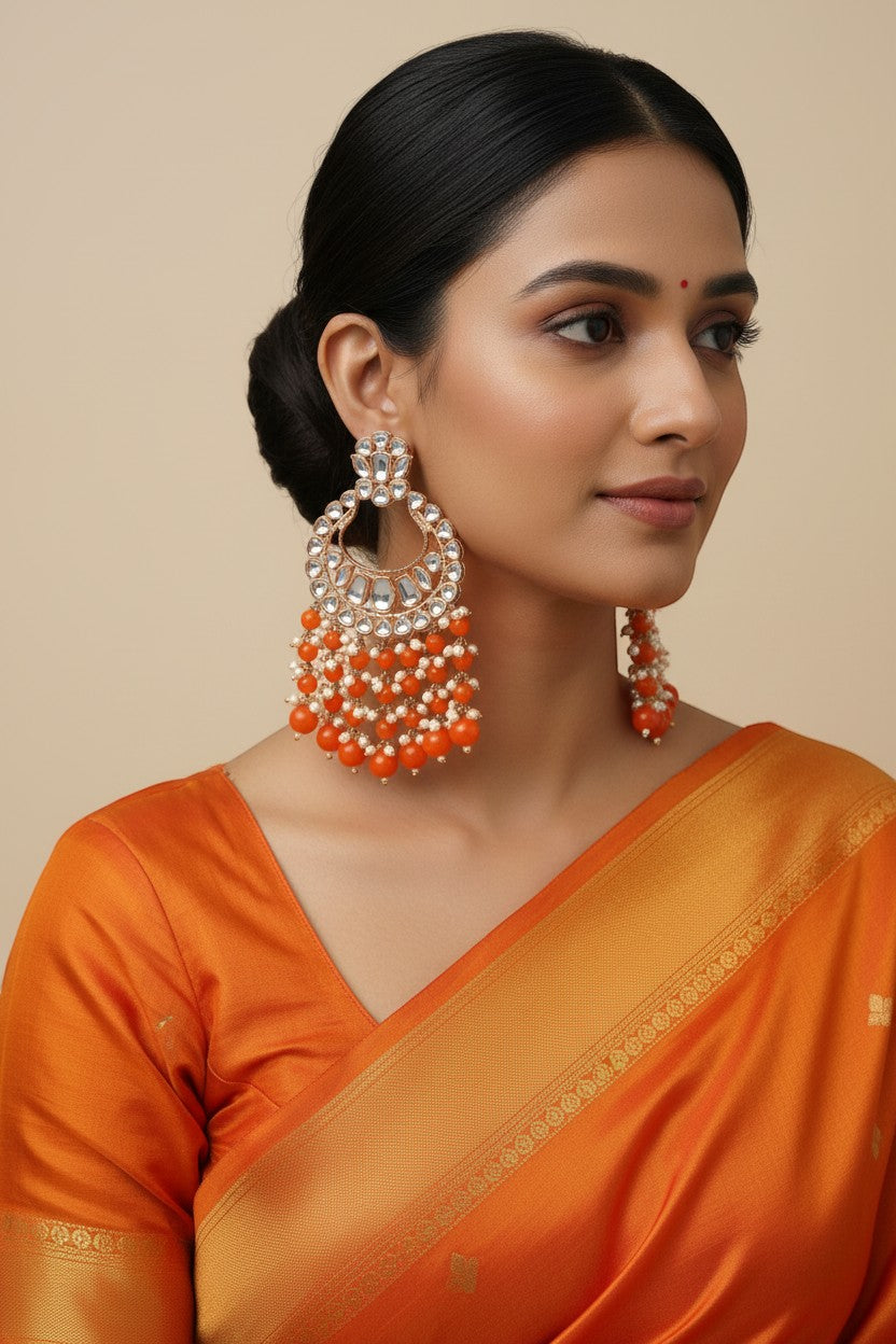 Naanu rose gold polki kundan chandbali earrings with orange coral bead fringe and pearl accents.