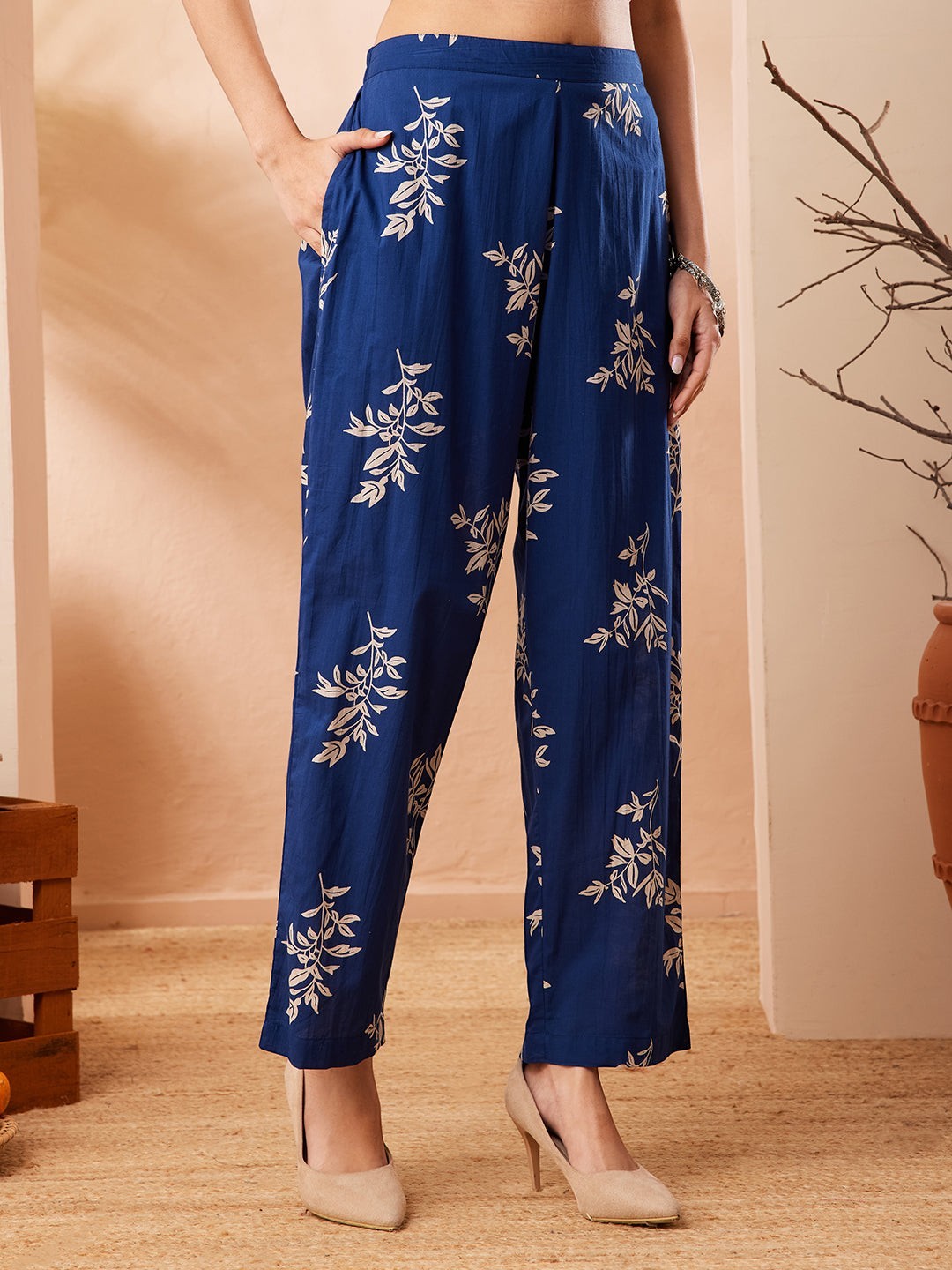 Naanu royal blue cotton straight pants with an ivory botanical leaf print and side pockets.