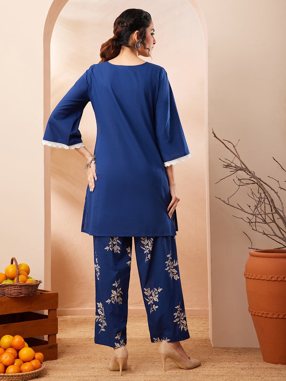 Naanu royal blue cotton co-ord set with botanical print straight pants and embroidered yoke. Features bell sleeves with lace trim.