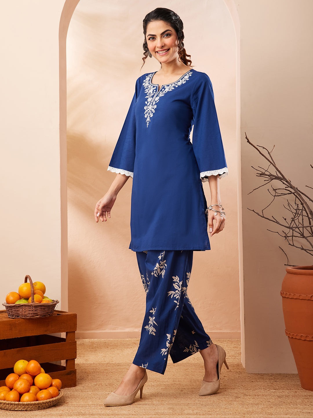 Naanu royal blue cotton co-ord set with white floral embroidered yoke and botanical print straight pants.