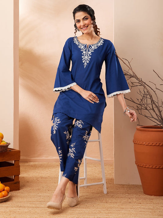 Naanu royal blue cotton co-ord set with white floral embroidery on yoke and botanical print pants.