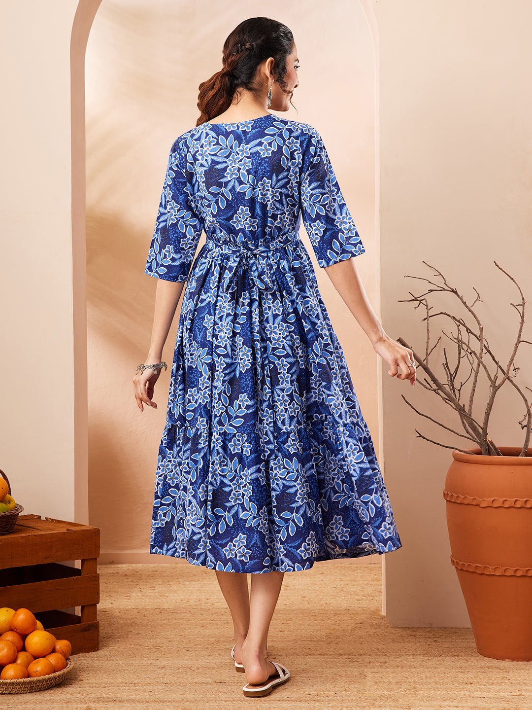 Naanu royal blue floral print tiered midi dress with 3/4 sleeves and tie-back waist. Ethnic fusion wear.