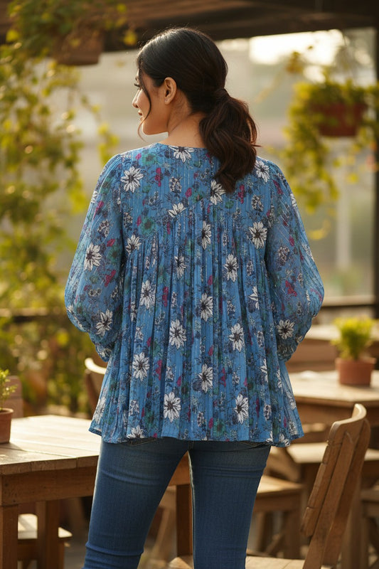 Naanu sky blue georgette pleated shirt top with large white daisy floral print and silver lurex stripes, full sleeves.
