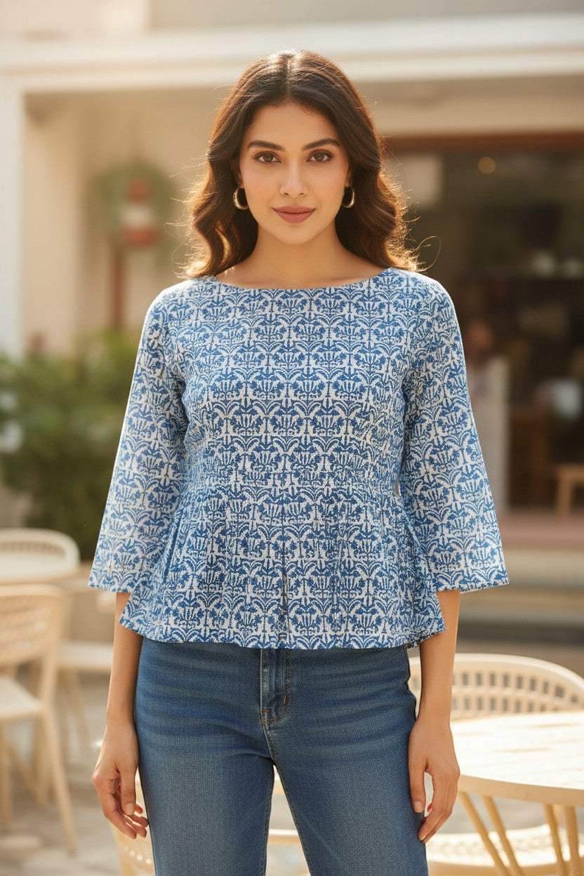 Naanu sky blue cotton peplum top with 3/4 sleeves and boat neck, featuring an all-over indigo lotus damask block print.