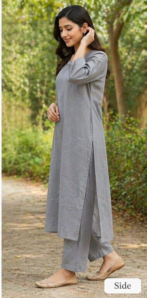 Naanu steel grey solid cotton kurta with straight pants. Features a round neckline, 3/4 sleeves, and side slits.