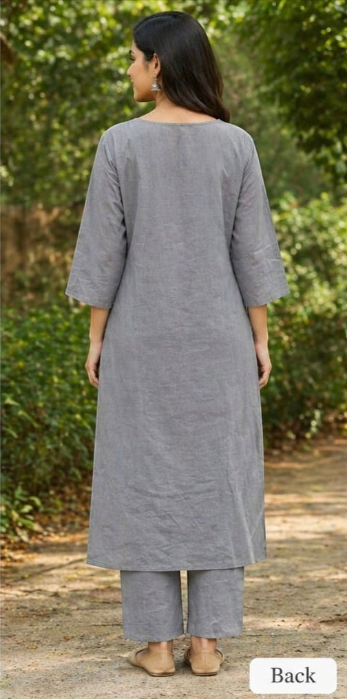 Naanu steel grey solid cotton kurta with straight 3/4 sleeves and matching straight pants, worn by a woman outdoors.