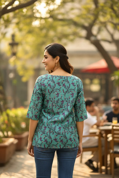 Naanu teal green cotton kurti with purple floral vine print and 3/4 sleeves.