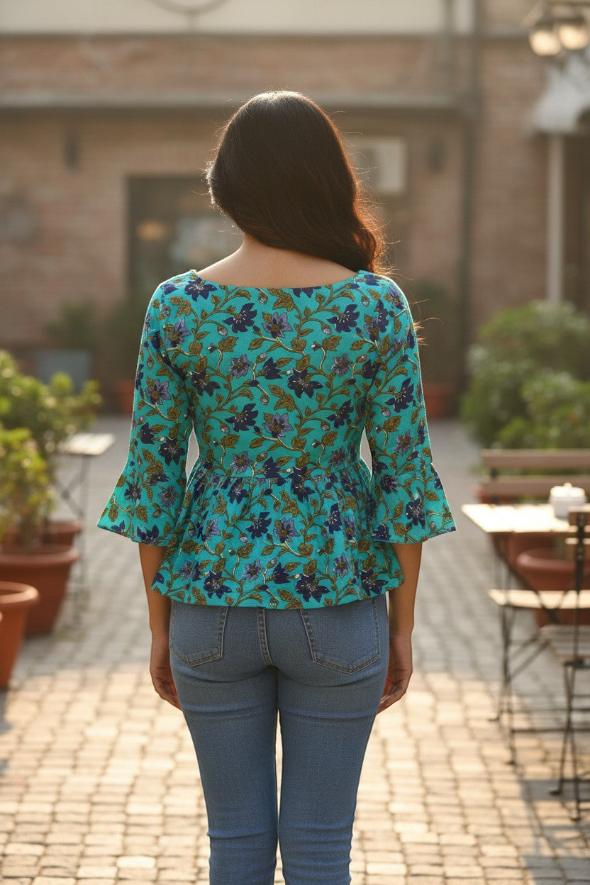 Naanu turquoise teal floral peplum top with 3/4 bell sleeves and square neck, made of 100% cotton.