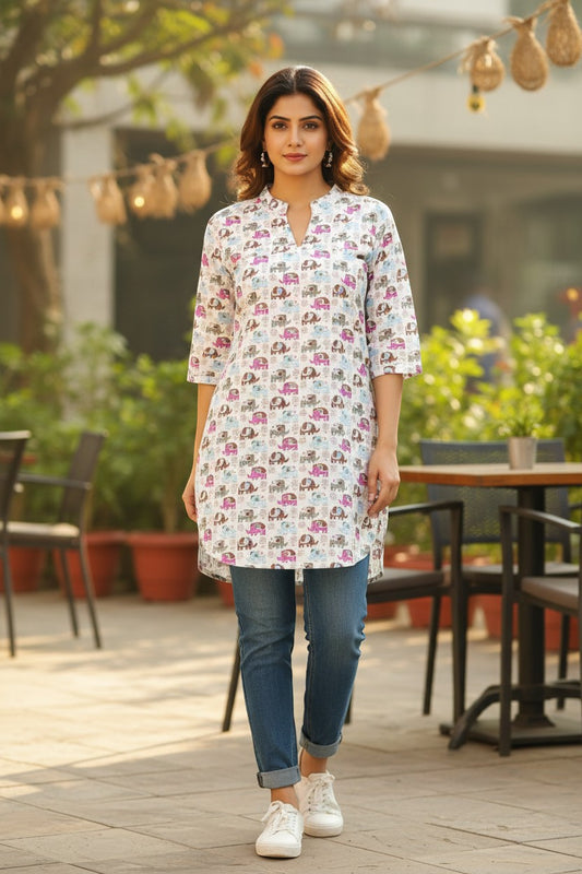 Naanu white short cotton kurti with colorful cartoon elephant print, V-notch neckline, and 3/4 sleeves.
