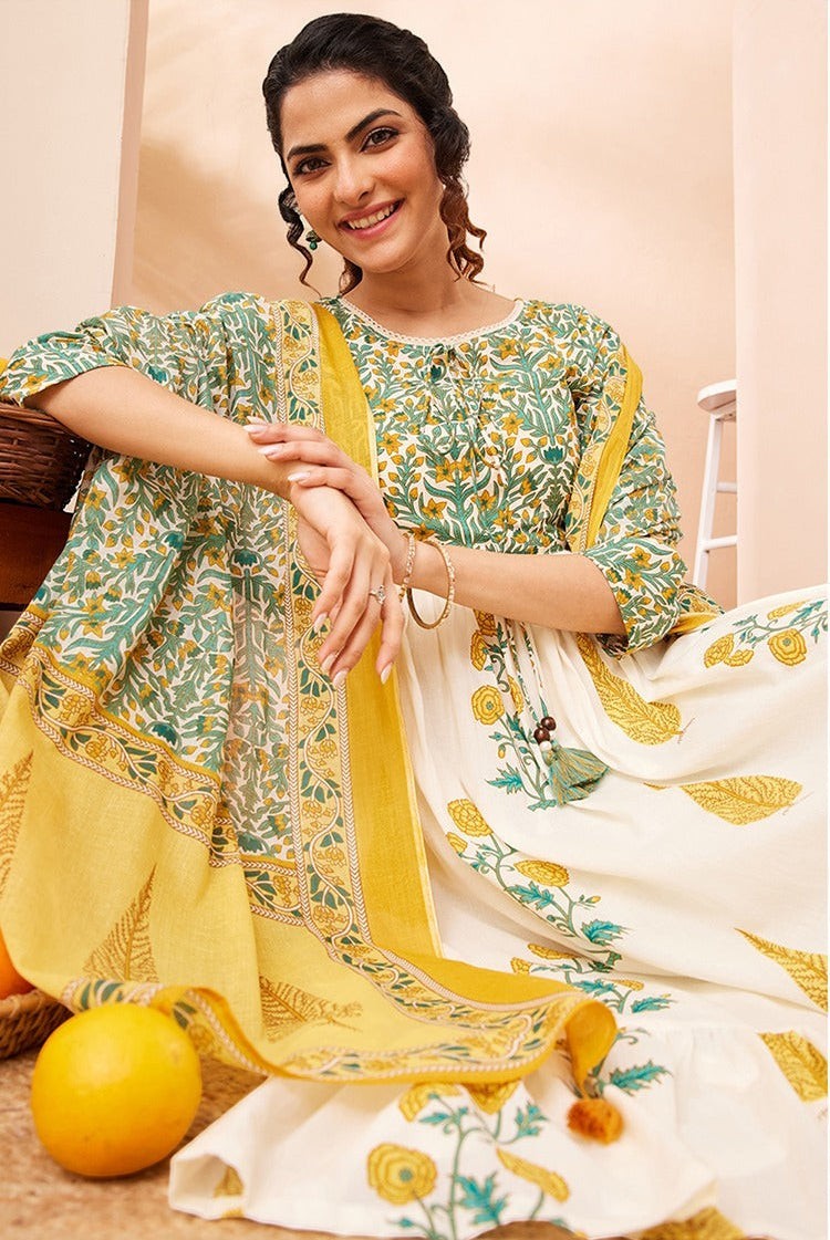 Naanu white and green floral block print Anarkali kurta set with yellow dupatta. Cotton, 3/4 sleeves, round neck, tiered hem.