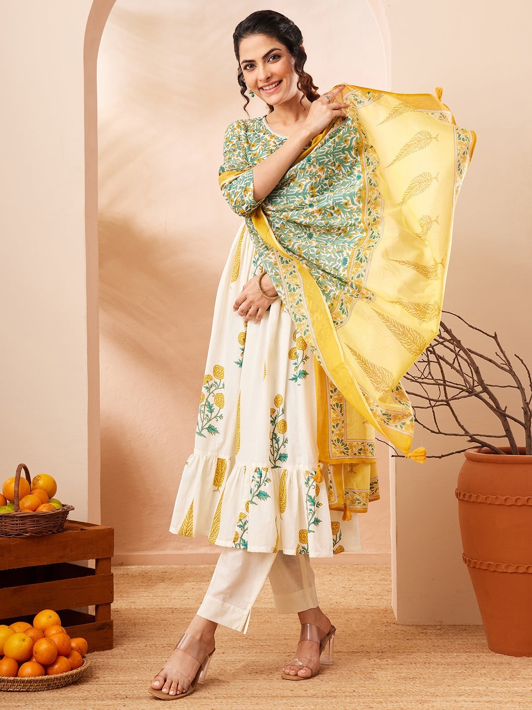 Naanu white and green floral block print Anarkali kurta set with yellow dupatta, tiered ruffle hem, 3/4 sleeves, round neck.