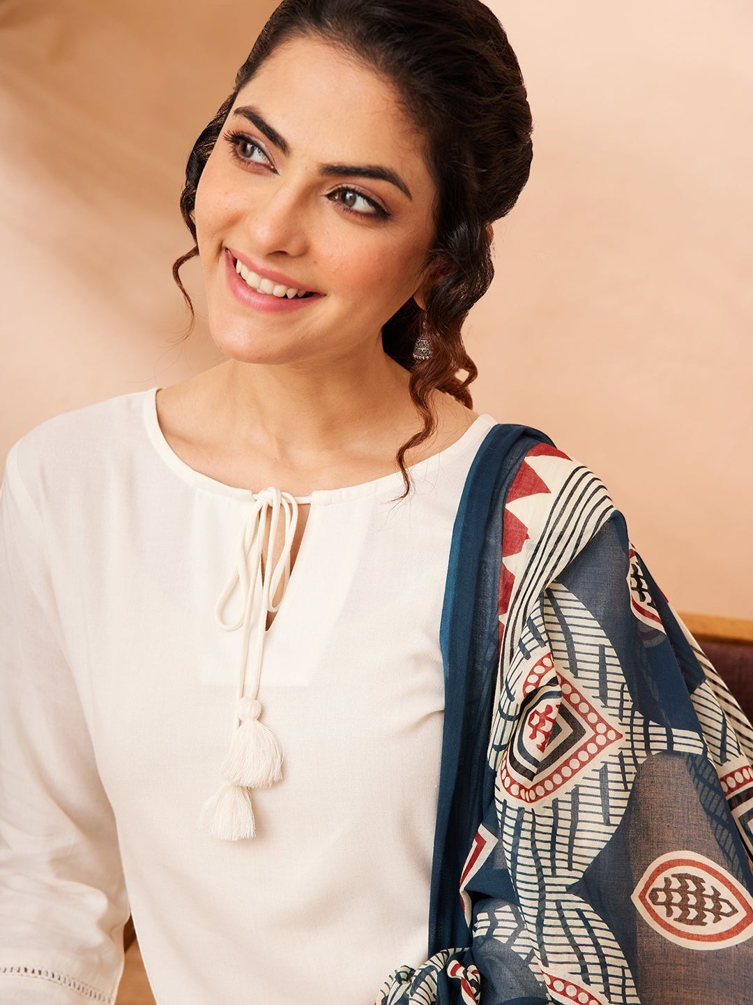 Naanu white rayon kurta with tie-up tassel detail and printed navy Ajrakh dupatta with tassel ends.