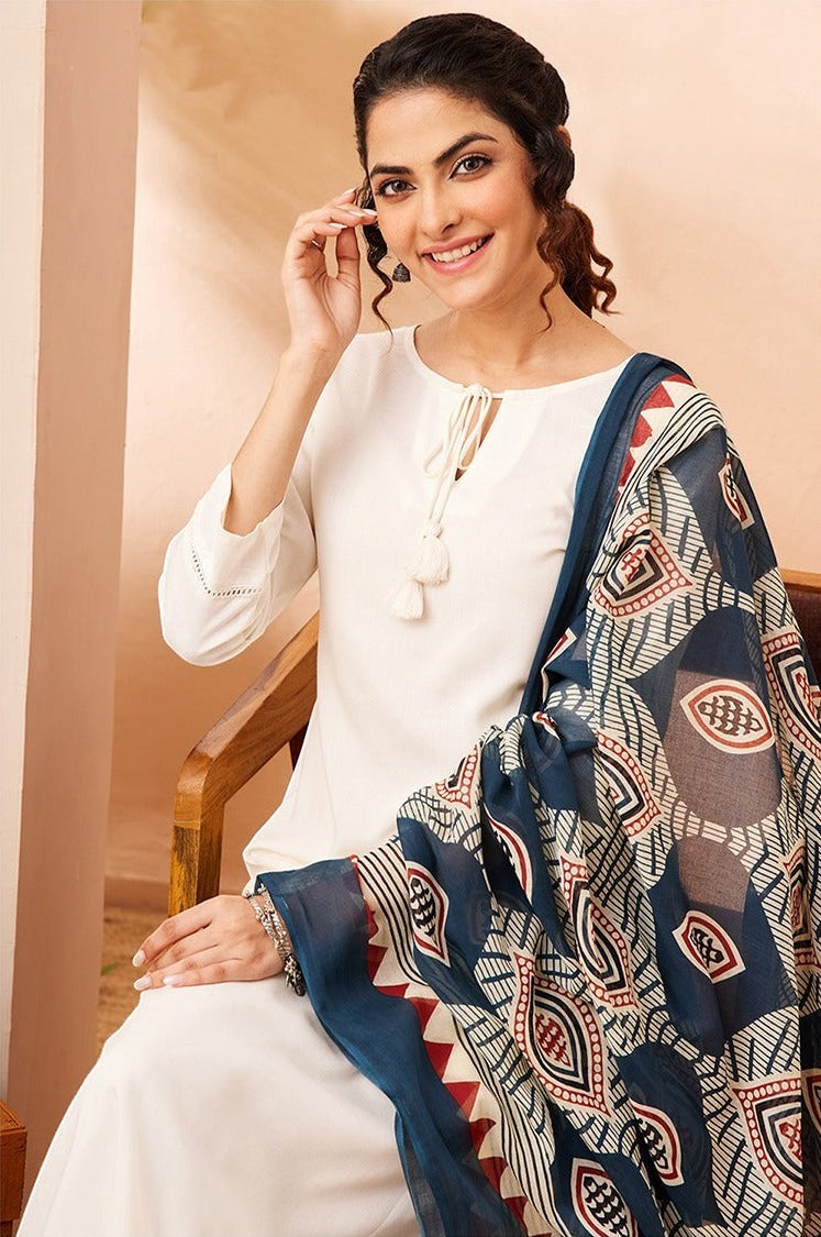 Naanu white rayon kurta set with a navy Ajrakh print dupatta. Features tie-up tassel detail and lace hem.