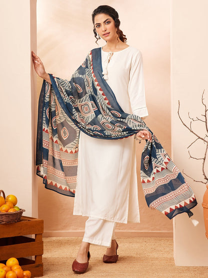 Naanu white rayon kurta set with wide-leg palazzo pants and a navy Ajrakh print dupatta with tassel ends.