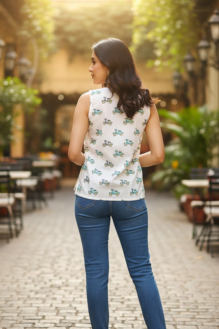 Naanu white sleeveless cotton top with teal and grey scooter print, V-neckline, and relaxed fit.