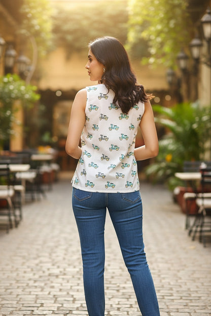Naanu white sleeveless cotton top with teal and grey scooter print, V-neckline, and relaxed fit.