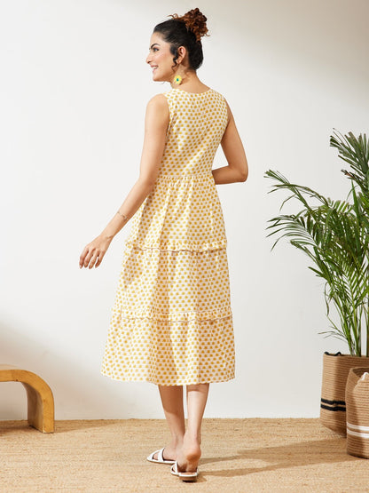 Naanu yellow butti print cotton midi dress with V-neck, empire waist, and double ruffle tiered hem.