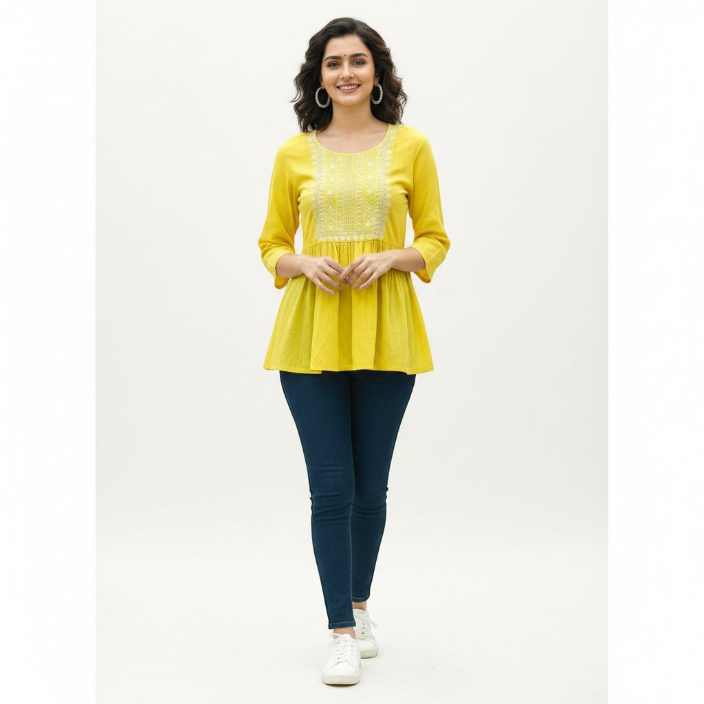 Naanu yellow cotton peplum top with white chikankari embroidery on the yoke and 3/4 sleeves.