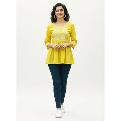 Naanu yellow cotton peplum top with white chikankari embroidery on the yoke and 3/4 sleeves.