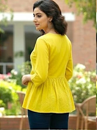Naanu yellow cotton peplum top with 3/4 sleeves and round neck, featuring white chikankari embroidery on the yoke.