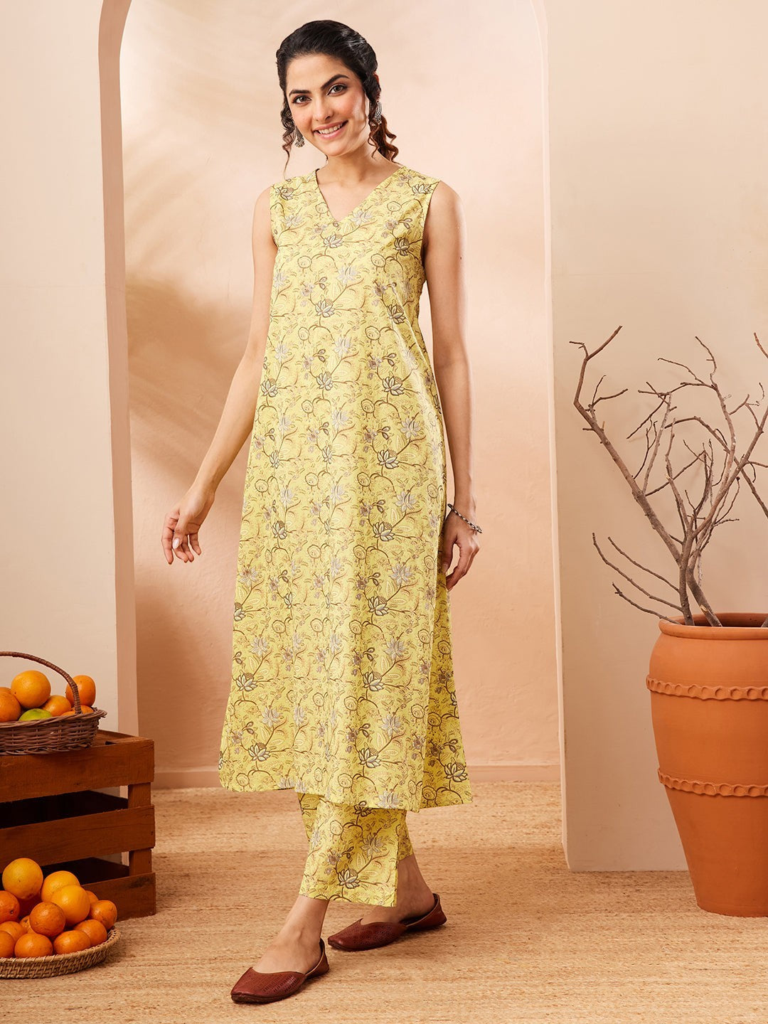 Naanu yellow lotus print sleeveless A-line kurta with V-neck and matching palazzo pants.